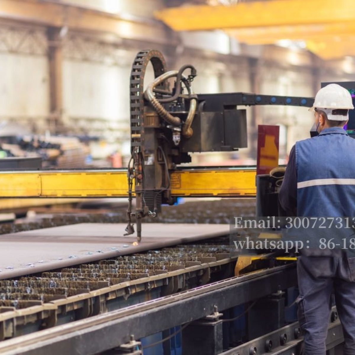 Steel worker on CNC plasma cutter machine